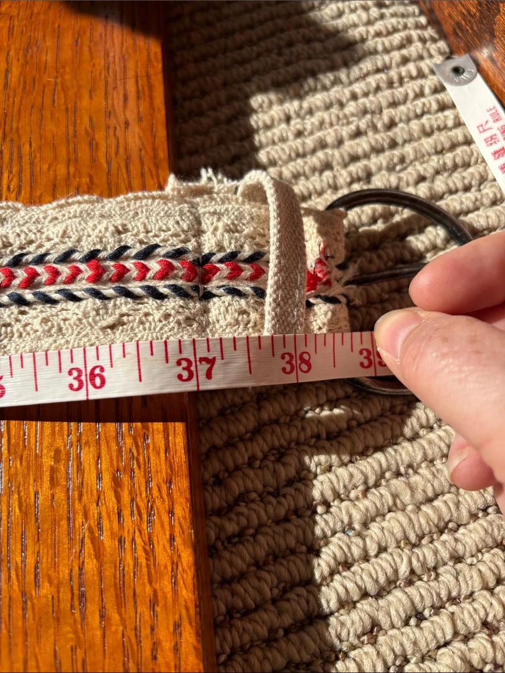 Canvas cream color crochet belt with red and blue embroidered accents. Size 7